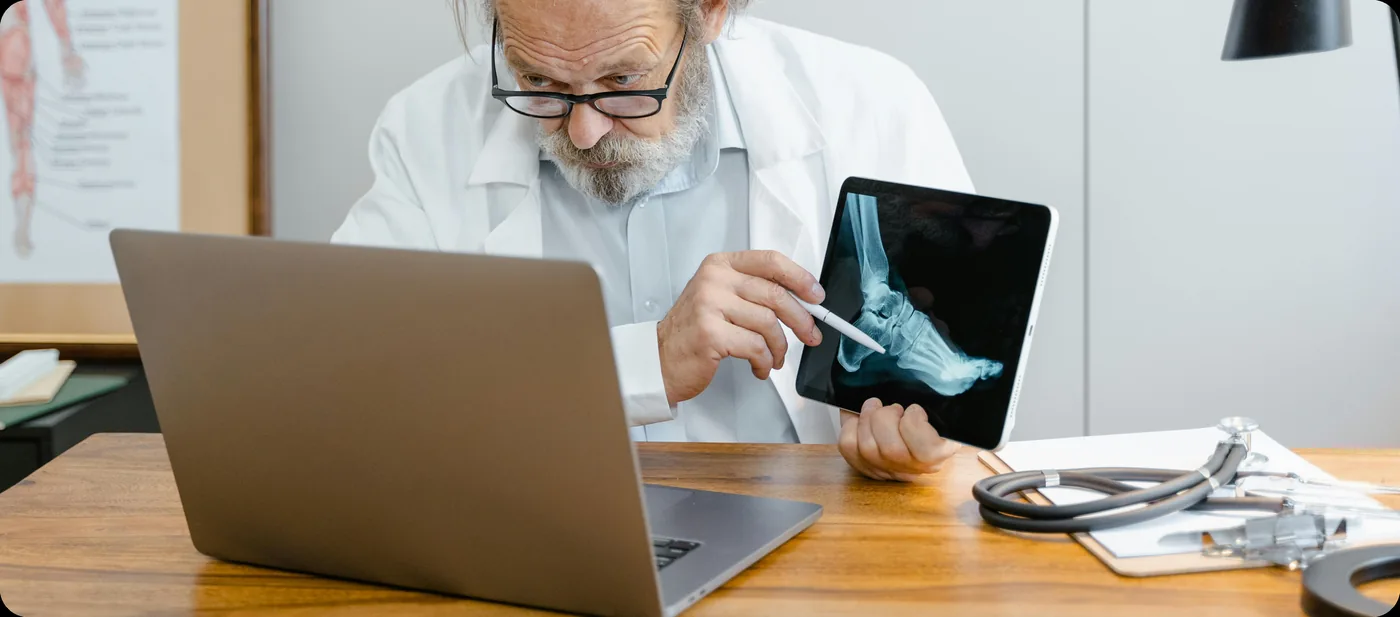 Doctor reviewing patient scans on a tablet