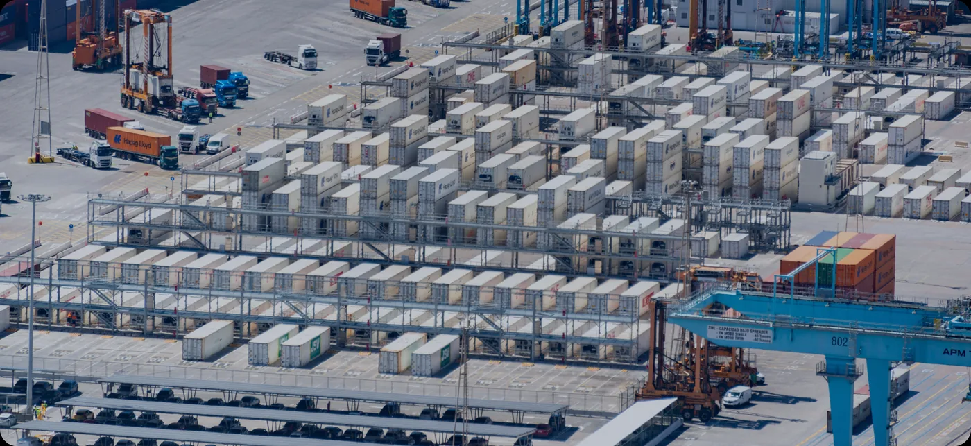 Freight containers stacked at a logistics yard