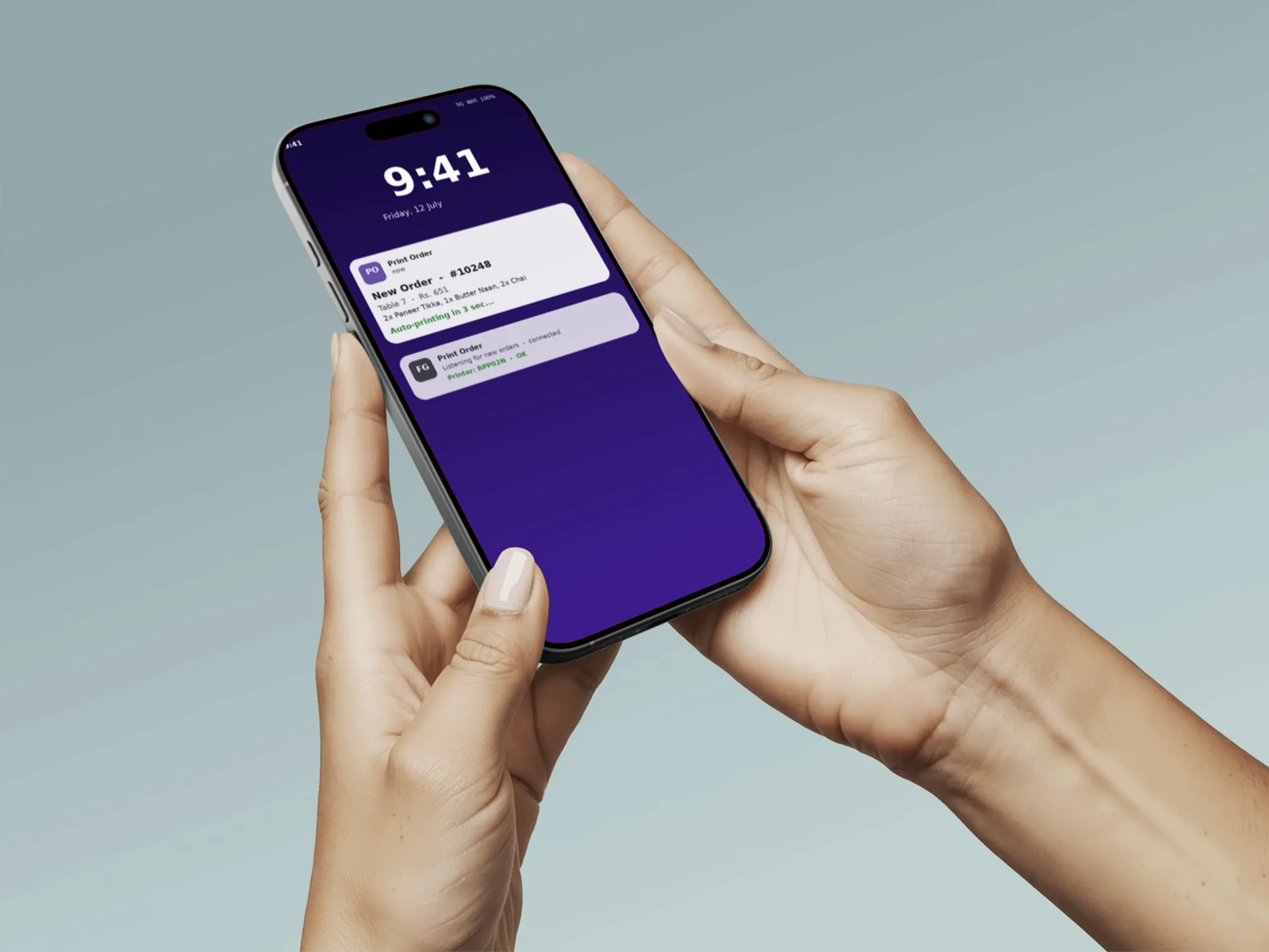 Hands holding a phone showing the Print Order lock screen notification